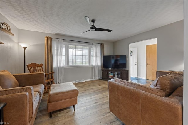 2440 Sir Lance Dr, Chesapeake, VA 23325 - living room featuring light wood-type flooring, ceiling fan, and a textured ceiling