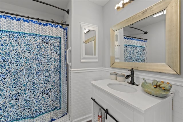 1312 Duncan Ln, Virginia Beach, VA 23455 - full bathroom with vanity, a wainscoted wall, a shower with shower curtain, and a decorative wall