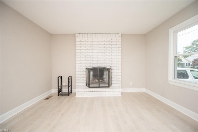 961 Hugo St, Norfolk, VA 23513 - unfurnished living room with wood finished floors and a brick fireplace