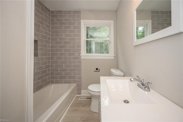 961 Hugo St, Norfolk, VA 23513 - full bath with wood finished floors, vanity, and shower / bathtub combination