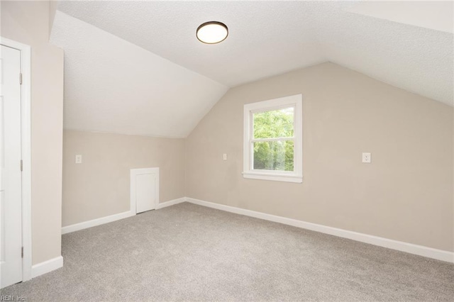 961 Hugo St, Norfolk, VA 23513 - additional living space with carpet flooring, a textured ceiling, and vaulted ceiling
