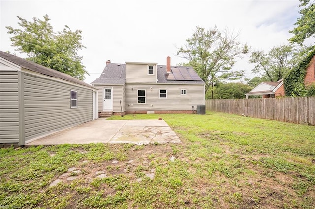 961 Hugo St, Norfolk, VA 23513 - back of property with a patio, solar panels, and a chimney