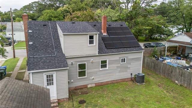 961 Hugo St, Norfolk, VA 23513 - back of property with a chimney, roof with shingles, and roof mounted solar panels