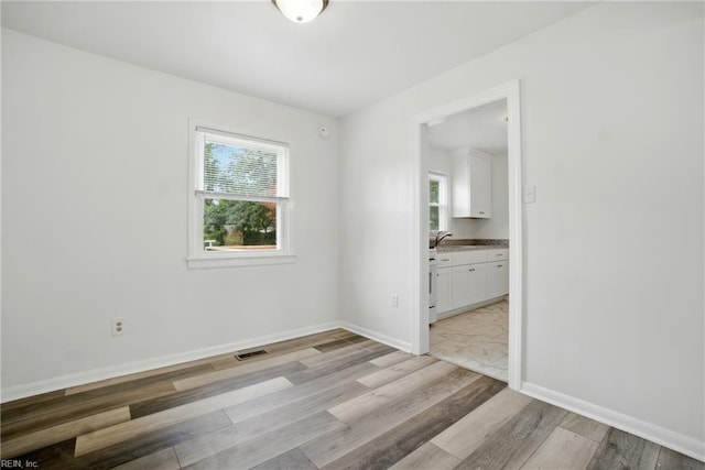 4400 Bart St, Portsmouth, VA 23707 - unfurnished room featuring light wood-type flooring and a sink