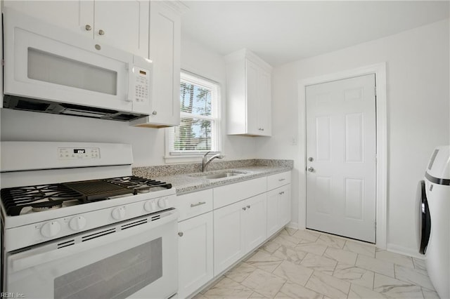 4400 Bart St, Portsmouth, VA 23707 - kitchen featuring white appliances, light marble finish flooring, white cabinetry, light stone countertops, and washer / dryer