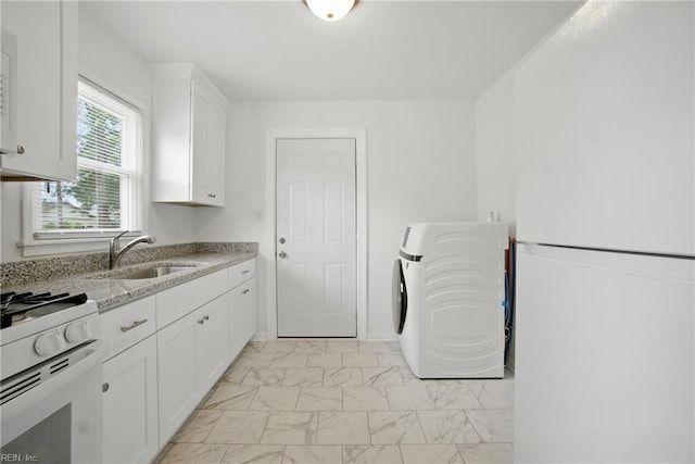 4400 Bart St, Portsmouth, VA 23707 - kitchen with washer / dryer, light marble finish flooring, white cabinets, light stone counters, and white appliances