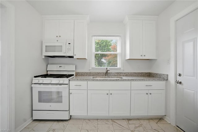 4400 Bart St, Portsmouth, VA 23707 - kitchen with white appliances, light marble finish floors, and white cabinetry