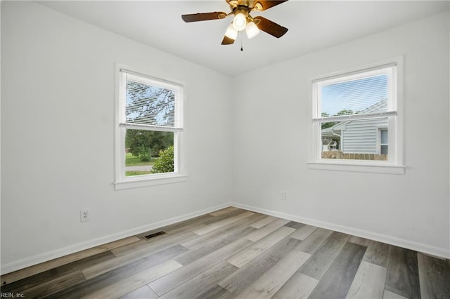 4400 Bart St, Portsmouth, VA 23707 - spare room with plenty of natural light, wood finished floors, and a ceiling fan