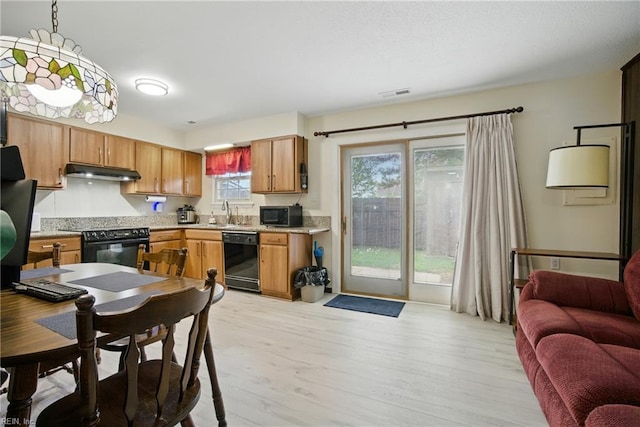 1733 Olde Buckingham Rd, Hampton, VA 23669 - kitchen with black appliances, under cabinet range hood, light wood-style flooring, light countertops, and open floor plan