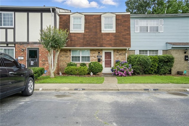 1733 Olde Buckingham Rd, Hampton, VA 23669 - multi unit property with brick siding, mansard roof, roof with shingles, and uncovered parking