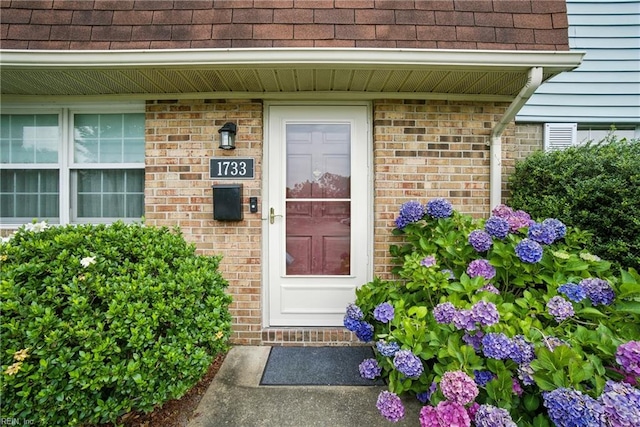 1733 Olde Buckingham Rd, Hampton, VA 23669 - view of exterior entry with roof with shingles and brick siding