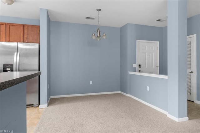 5205 Nuthall Dr Unit 202, Virginia Beach, VA 23455 - kitchen with stainless steel fridge with ice dispenser, brown cabinetry, a chandelier, light carpet, and decorative light fixtures