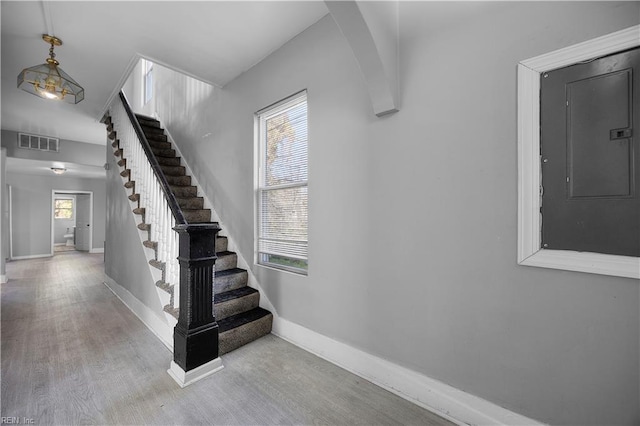 1047 26th St, Newport News, VA 23607 - stairs with electric panel, wood finished floors, and healthy amount of natural light