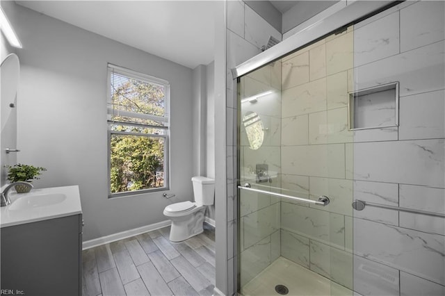 1047 26th St, Newport News, VA 23607 - full bathroom with vanity, a shower stall, and wood finished floors