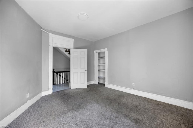 1047 26th St, Newport News, VA 23607 - empty room with dark colored carpet and baseboards