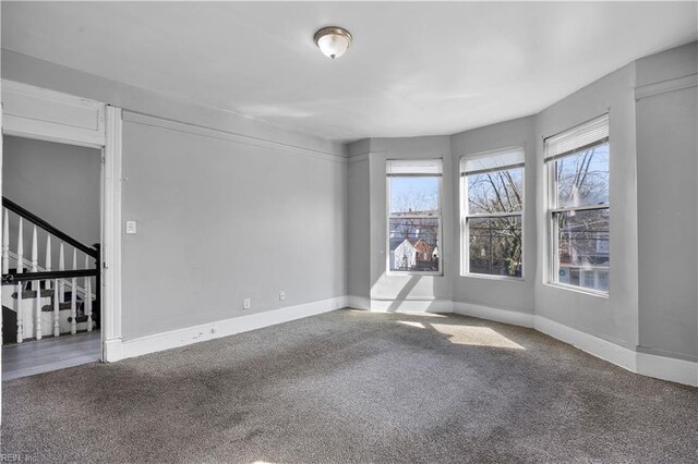 1047 26th St, Newport News, VA 23607 - empty room with carpet flooring and stairs