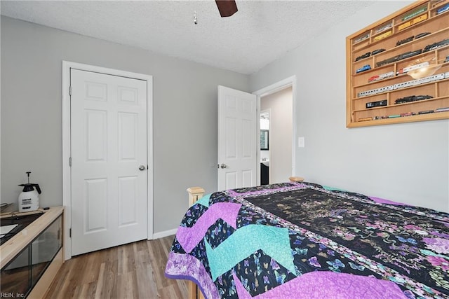 1712 Willwood Ct, Virginia Beach, VA 23464 - bedroom with wood finished floors, ceiling fan, and a textured ceiling