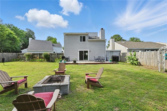 1712 Willwood Ct, Virginia Beach, VA 23464 - back of property with a fire pit, a fenced backyard, a deck, and a chimney