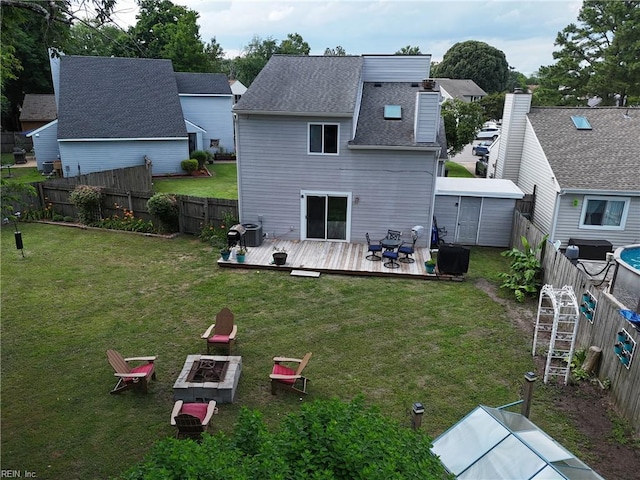 1712 Willwood Ct, Virginia Beach, VA 23464 - rear view of house with a fire pit, a deck, a fenced backyard, and a shingled roof