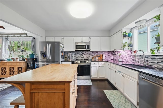 1712 Willwood Ct, Virginia Beach, VA 23464 - kitchen with appliances with stainless steel finishes, backsplash, white cabinetry, a center island, and dark wood finished floors