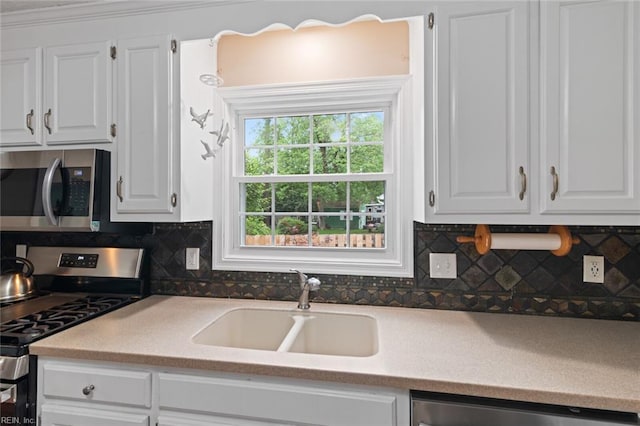 301 Ashland Ct, Newport News, VA 23606 - kitchen with stainless steel appliances, white cabinetry, backsplash, and light countertops