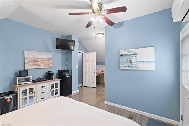 301 Ashland Ct, Newport News, VA 23606 - bedroom with a wall mounted AC, vaulted ceiling, wood finished floors, and ceiling fan