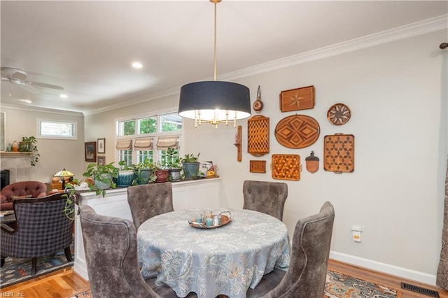 3516 Colmar Quarter Quarter, Norfolk, VA 23509 - dining area with ornamental molding, wood finished floors, a ceiling fan, a tile fireplace, and recessed lighting