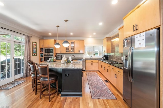 3516 Colmar Quarter Quarter, Norfolk, VA 23509 - kitchen with appliances with stainless steel finishes, light brown cabinets, crown molding, light wood-style floors, and an island with sink
