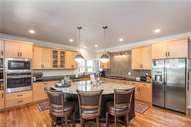 3516 Colmar Quarter Quarter, Norfolk, VA 23509 - kitchen featuring appliances with stainless steel finishes, light brown cabinetry, ornamental molding, a breakfast bar, and a kitchen island