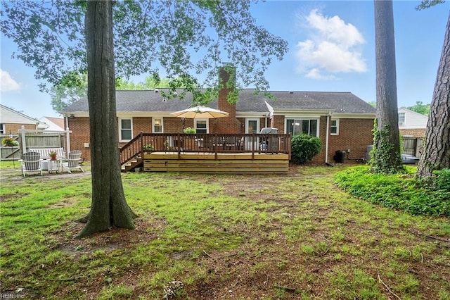 609 Robinold Ct, Chesapeake, VA 23322 - rear view of house featuring brick siding, a wooden deck, and a chimney