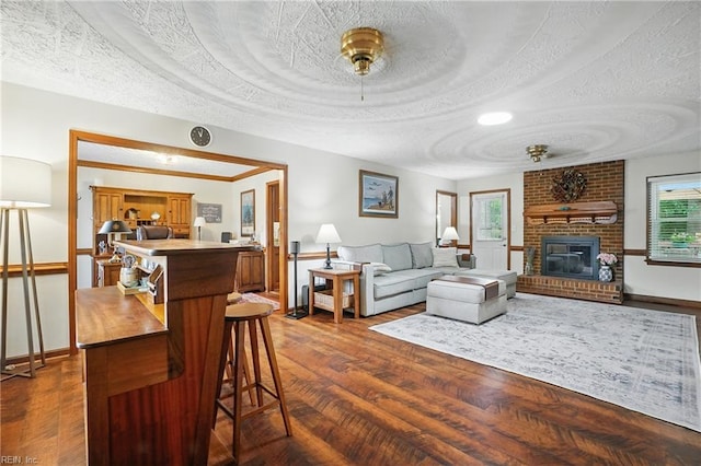 609 Robinold Ct, Chesapeake, VA 23322 - living room with a fireplace, dark wood-style flooring, and a textured ceiling