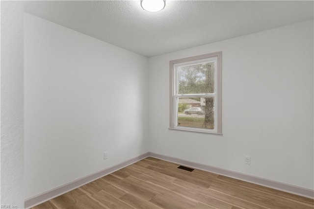 2370 Pruden Blvd, Suffolk, VA 23434 - unfurnished room featuring light wood finished floors and a textured ceiling