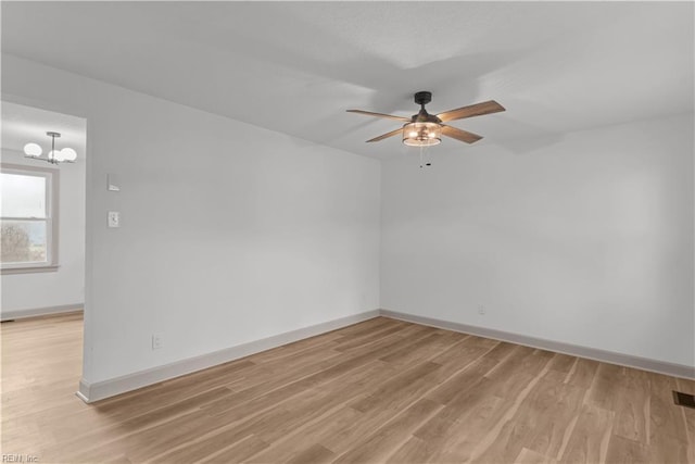 2370 Pruden Blvd, Suffolk, VA 23434 - empty room featuring ceiling fan, light wood-style floors, and a chandelier