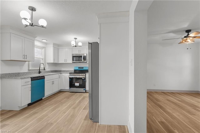 2370 Pruden Blvd, Suffolk, VA 23434 - kitchen with stainless steel appliances, a chandelier, white cabinets, light wood-style flooring, and a ceiling fan