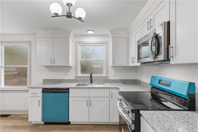 2370 Pruden Blvd, Suffolk, VA 23434 - kitchen featuring stainless steel appliances, light wood-type flooring, white cabinets, a chandelier, and a textured ceiling