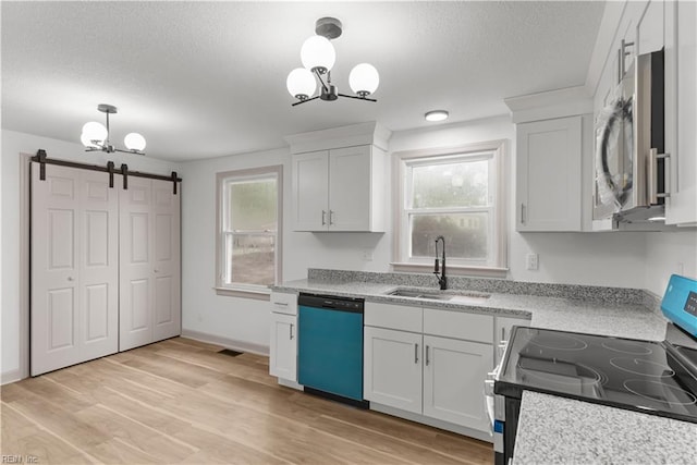 2370 Pruden Blvd, Suffolk, VA 23434 - kitchen with appliances with stainless steel finishes, a textured ceiling, a barn door, a chandelier, and white cabinetry