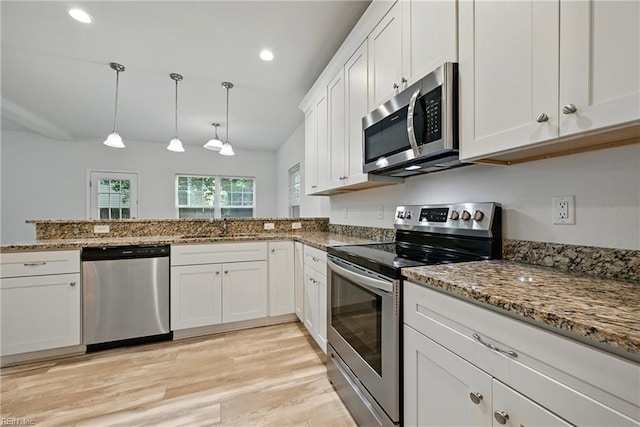 3005 Overbrook Ave, Norfolk, VA 23513 - kitchen with stainless steel appliances, light wood finished floors, stone counters, white cabinetry, and pendant lighting