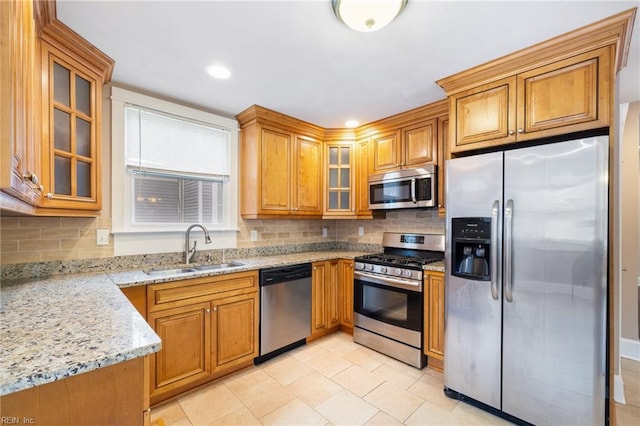 1718 Fontainebleau Cres, Norfolk, VA 23509 - kitchen featuring appliances with stainless steel finishes, brown cabinetry, light stone countertops, backsplash, and recessed lighting