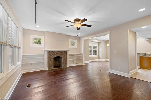 1718 Fontainebleau Cres, Norfolk, VA 23509 - unfurnished living room featuring wood finished floors, a tile fireplace, a ceiling fan, and recessed lighting
