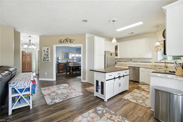 609 Trumpet Ct, Chesapeake, VA 23323 - kitchen featuring stainless steel appliances, a chandelier, white cabinetry, dark wood-style floors, and decorative light fixtures