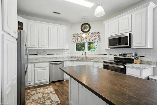 609 Trumpet Ct, Chesapeake, VA 23323 - kitchen with stainless steel appliances, decorative backsplash, and white cabinetry
