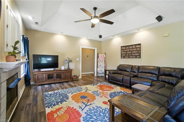 609 Trumpet Ct, Chesapeake, VA 23323 - living room with a ceiling fan, a tray ceiling, dark wood-style floors, and a tiled fireplace