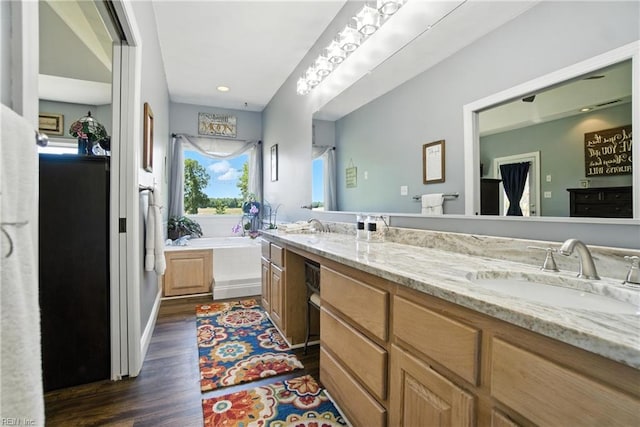 609 Trumpet Ct, Chesapeake, VA 23323 - bathroom with double vanity, wood finished floors, and a bath