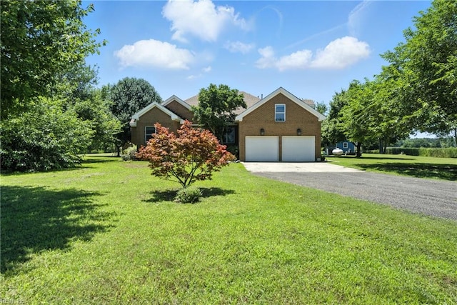 609 Trumpet Ct, Chesapeake, VA 23323 - view of front of house with gravel driveway, a garage, and a front lawn