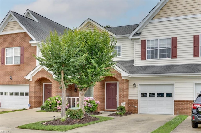 1004 Rustads Cir, Williamsburg, VA 23188 - traditional-style house featuring driveway, brick siding, an attached garage, and roof with shingles