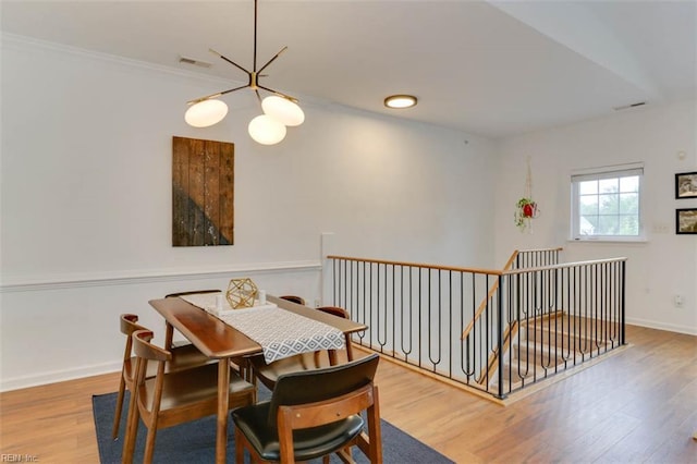 1004 Rustads Cir, Williamsburg, VA 23188 - dining room featuring a chandelier, wood finished floors, and ornamental molding