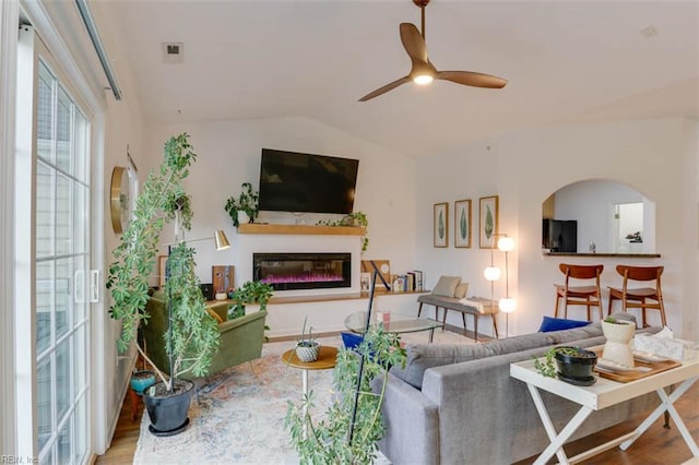 1004 Rustads Cir, Williamsburg, VA 23188 - living room with wood finished floors, a glass covered fireplace, a ceiling fan, and lofted ceiling
