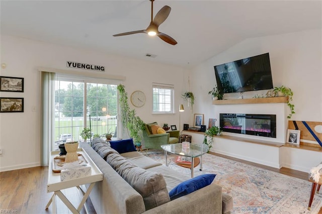 1004 Rustads Cir, Williamsburg, VA 23188 - living room with wood finished floors, a ceiling fan, a glass covered fireplace, and lofted ceiling