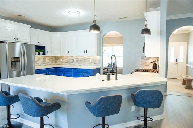 1305 Simms Arch, Chesapeake, VA 23322 - kitchen featuring arched walkways, blue cabinets, decorative backsplash, and crown molding
