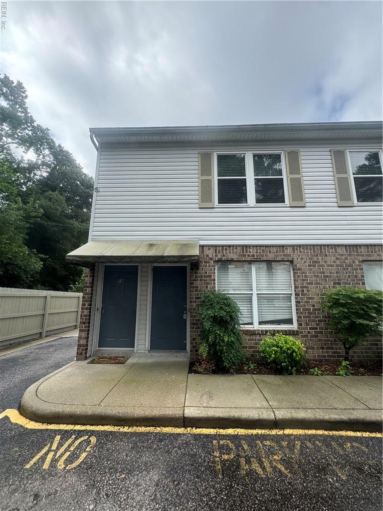 8570 Chesapeake Blvd Unit 17, Norfolk, VA 23503 - view of property with brick siding and uncovered parking